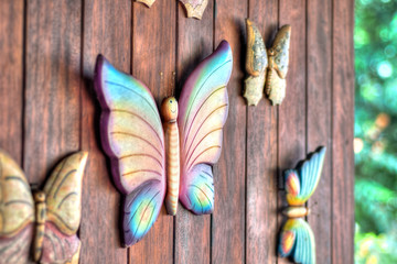 Decorative wooden butterflies on a wooden wall