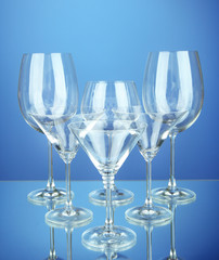 Cocktail and wine glasses, on blue background