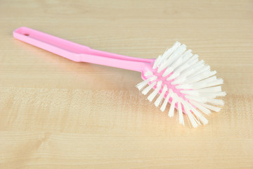 Toilet brush on wooden background