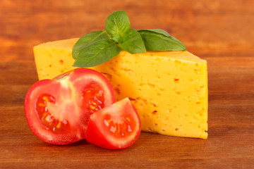 Cheese,basil and tomato on wooden background