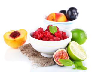 Raspberries in small bowl on sackcloth isolated on white