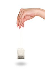 Tea bag in a female hand.