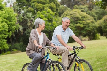 Naklejka premium Senior couple on cycle ride in countryside