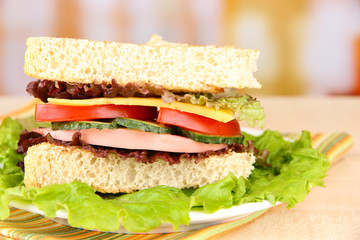 Fresh and tasty sandwich on plate on table on light background
