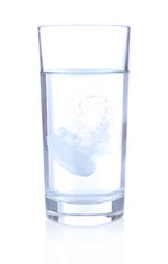 Glass with efervescent tablet in water with bubbles isolated