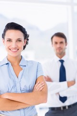 Obraz premium Portrait of a young businesswoman with arms crossed