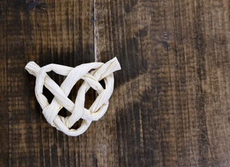 Heart shape from rope, on wooden background