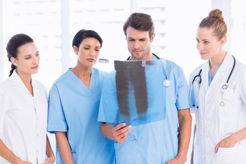 Group of doctors and surgeons examining x-ray