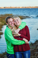 Fototapeta na wymiar Young couple on banks of river