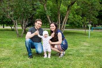 Obraz premium Happy family: mother, father and daughter baby