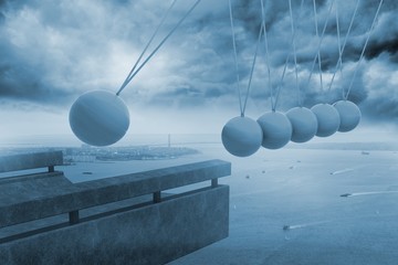 Newtons cradle above coastline