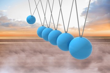 Newtons cradle above beach