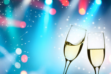 Glasses with champagne against holiday lights
