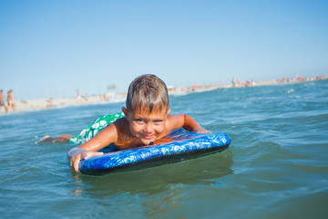 Fototapeta na wymiar boy has fun with the surfboard