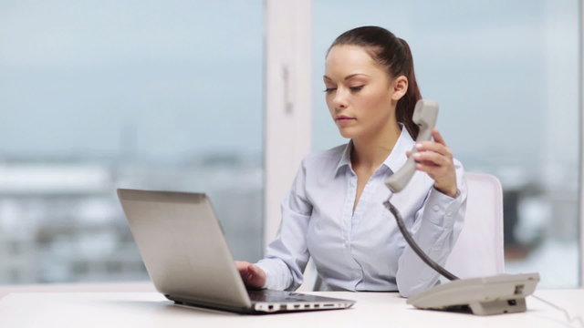 serious businesswoman with phone in office