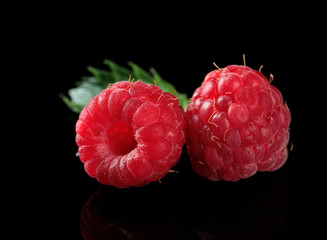Ripe sweet raspberries on dark background
