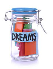 Dreams written on color paper in glass jar, isolated on white
