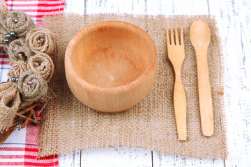 Fototapeta na wymiar Rustic table setting with plate, fork and spoon, on wooden