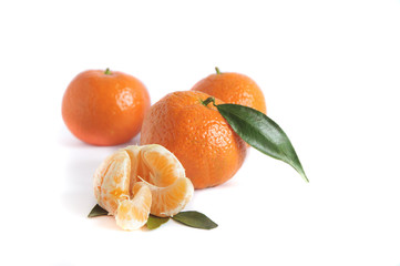 tangerine with slices an leaves isolated on white