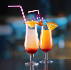 Glasses of tasty cocktails on bright background