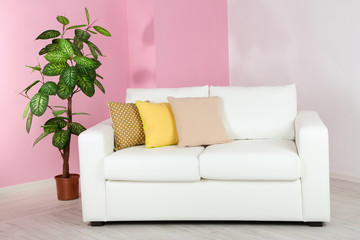 White sofa in room on pink wall background