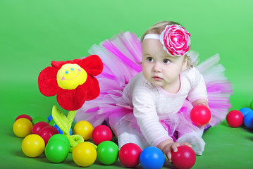 Small girl in rose suit on green background