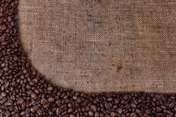 Frame of coffee beans on vintage sackcloth.