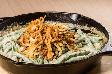 Fried onions with beans in a cast iron skillet