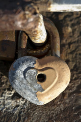 Heart shaped love locks on the stone bridge. Wedding traditions.
