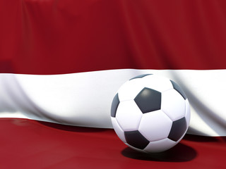 Flag of latvia with football in front of it