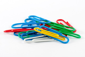 Colored paper clips on a white background.