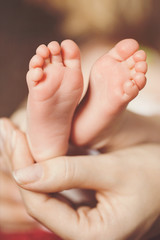 Baby hands and feet and hands Mom
