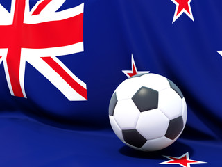 Flag of new zealand with football in front of it