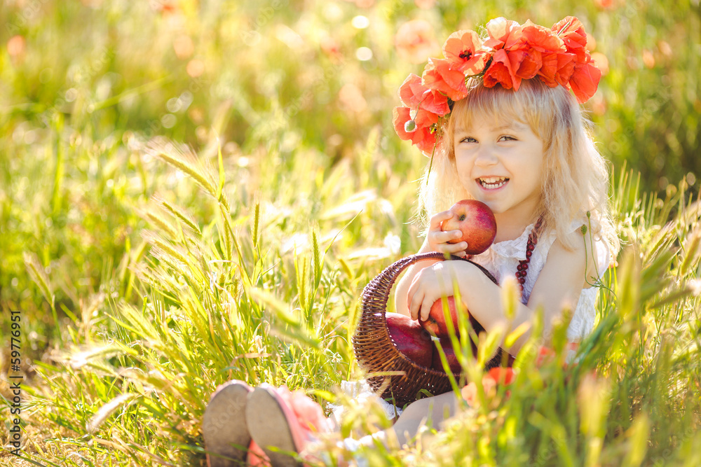 Wall mural cute child girl in poppy field