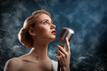 beautiful blonde woman singer with a microphone