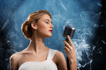 beautiful blonde woman singer with a microphone