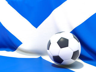 Naklejka premium Flag of scotland with football in front of it