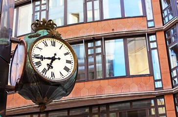 Fototapeta na wymiar Old street clock on street in Stockholm, Sweden