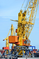 Port cargo crane over blue sky background