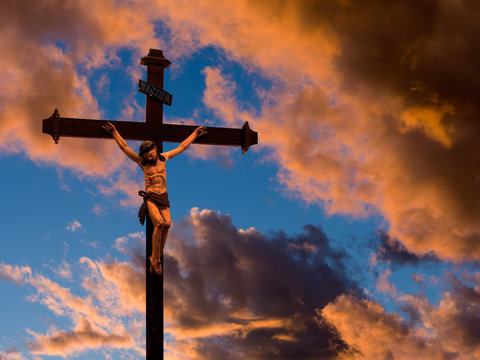 Crucified Christ over red evening sky
