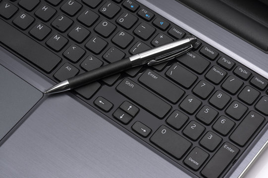 laptop with a pen