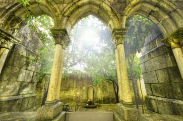 Ancient gothic arches in the myst. Fantasy landscape in Evora.