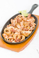 Fried Squid Rings - Squid rings with red pepper in a sizzle pan