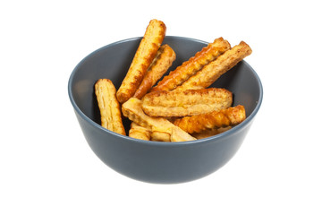 Puff pastry sticks  on a plate on isolated background
