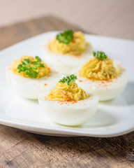 Deviled eggs garnished with parsley and paprika