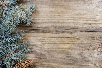 Fir with cones on wooden background. Top view, copy space