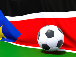 Flag of south sudan with football in front of it