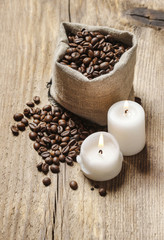 Jute sack of coffee beans on wooden table, copy space