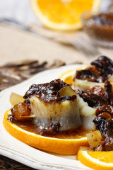 Pickled herring rolls with dried fruits and plum sauce