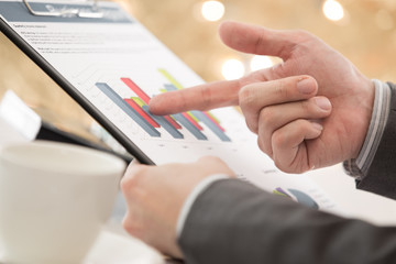 graphs and charts analyzed by businessman
